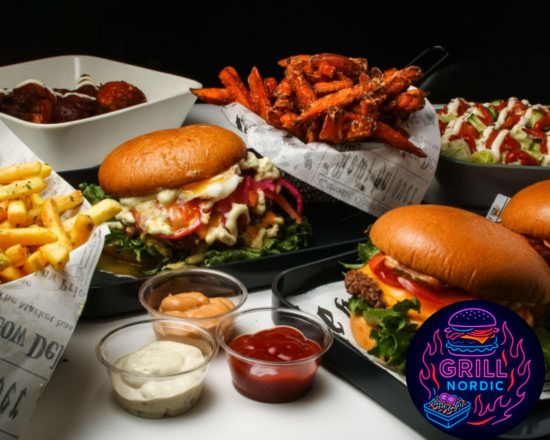 A spread of Grill Nordic burgers, fries, wings and dips